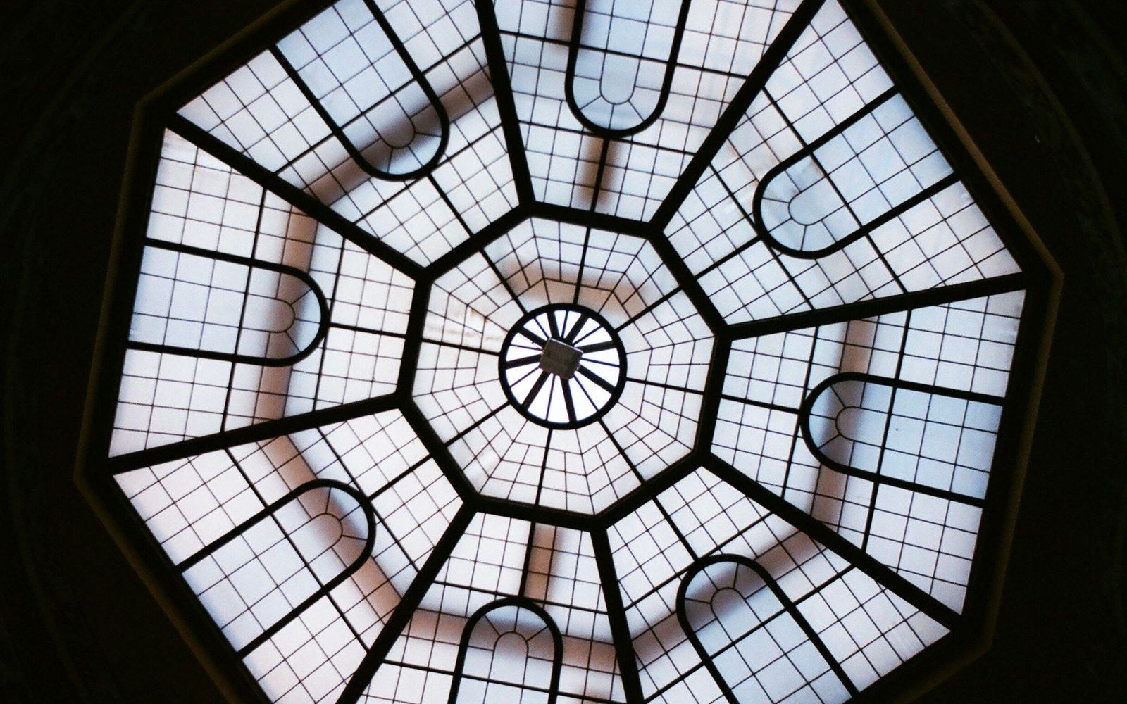Octagonal glass skylight with a grid pattern radiating from a central circular hub